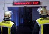 Feuerwehrleute vor Einsatzdisplay im Gerätehaus